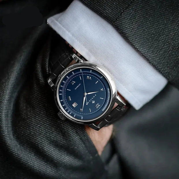 Luxury watch with blue dial and black strap on a person wearing a suit, branded 'Poniger'.