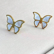 Elegant 18K gold-plated butterfly earrings with white enamel detail from the 18K Butterflies Jewelry Set, displayed on soft fabric.