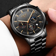 Luxury watch with black dial and silver metal strap on a wrist.