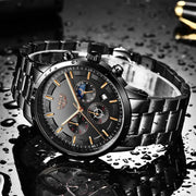 Luxury watch with black dial and metallic band on a reflective surface