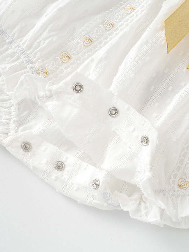 Snap-button closure detail on the baby girls' floral embroidered onesie, designed for easy diaper changes and all-day comfort.