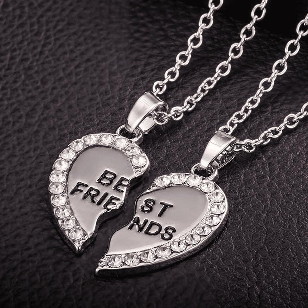 Silver-toned Custom Couple Necklaces - BondedHearts™ Heart Set with rhinestone border and 'Best Friends' engraving on each half.