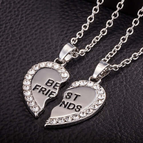 BondedHearts™ Custom Couple Necklaces in silver with crystal-studded heart halves engraved with 'Best Friends'.