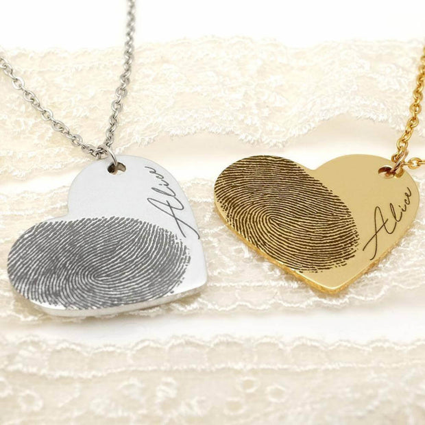 Silver and gold Fingerprint Heart Necklaces with 'Alice' engraving, custom memorial jewelry in stainless steel and gold finishes.