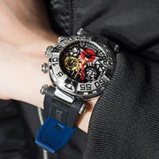 Close-up of a person wearing a detailed wristwatch with a blue strap.