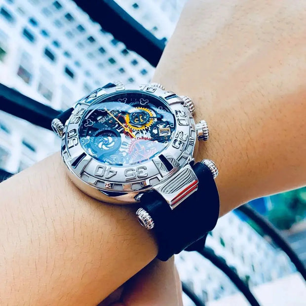 Luxury watch with intricate design on a wrist, blurred cityscape background