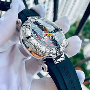 Watch with black strap held by white gloves against a blurred outdoor background